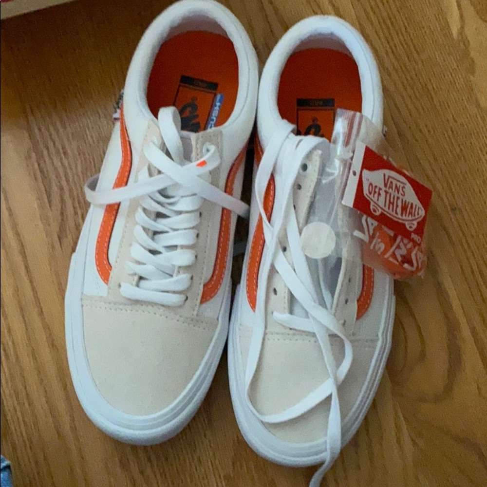 - vans orange and black and white checkered shoes